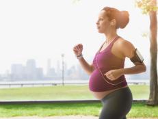 Pregnant mixed race woman power walking in park