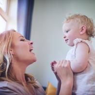 Shot of an adorable baby girl bonding with her mother at home