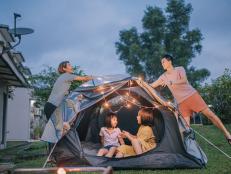 Asian chinese family putting on string light decorating camping at backyard of their house staycation weekend activities
