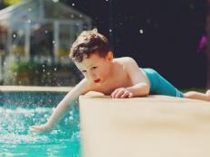 a little boy at poolside in summer