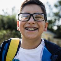School age boy laughing outside