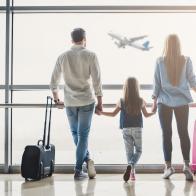 Family in airport. Attractive young woman, handsome man and their cute little daughter are ready for traveling! Happy family concept.