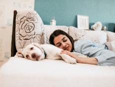 Woman relax on bed with her dog.