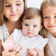 Three pretty little blond girls close up