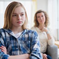 Caucasian mother and daughter arguing in living room