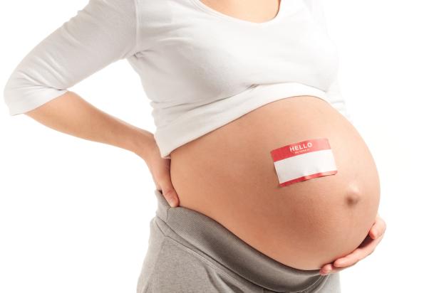 Pregnant Woman with Name Tag on Bare Belly