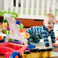 Baby crawling and smiling, toys, crib