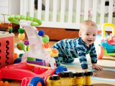 Baby crawling and smiling, toys, crib
