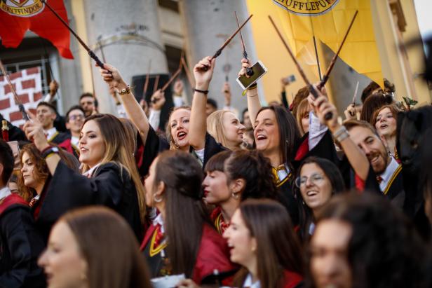 Faculty of medicine first year students walk down a hall while seniors paint them with different color paints and glitter as part of an annual tradition during a celebration in honor of their patron Saint Lucas at Granada University on October 17, 2019 in Granada. The fourth-year students, dressed as characters from the Harry Potter movies, organize this year event. 
 (Photo by Fermin Rodriguez/NurPhoto via Getty Images)