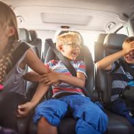 Three kids laughing in car on a road trip. Kids are aged 11 and 8. The kids are laughing and playing. Sunny summer day.
Nikon D810.