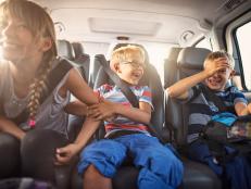 Three kids laughing in car on a road trip. Kids are aged 11 and 8. The kids are laughing and playing. Sunny summer day.
Nikon D810.