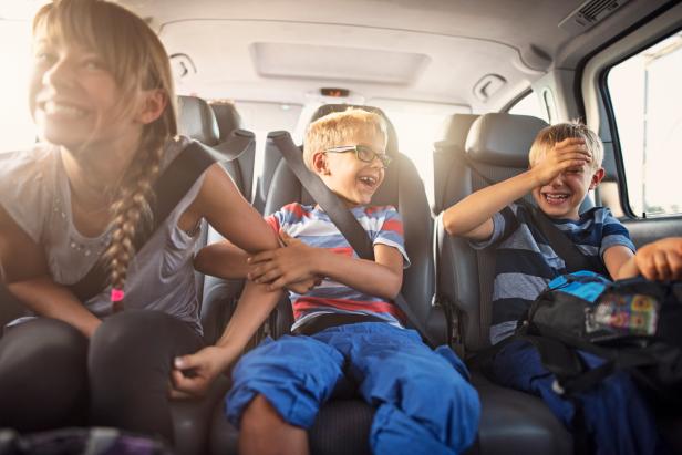 Three kids laughing in car on a road trip. Kids are aged 11 and 8. The kids are laughing and playing. Sunny summer day.
Nikon D810.