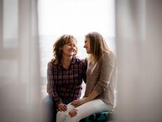 Affectionate smiling mother and daughter facing each other