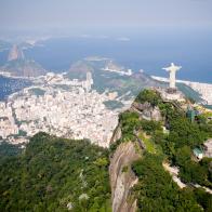 Aerial view of Rio de Janeiro on a sunny day taken from a helicopter.  In view are the landmarks Christ the Redeemer and Sugarloaf Mountain.