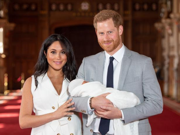 WINDSOR, ENGLAND - MAY 08: Prince Harry, Duke of Sussex and Meghan, Duchess of Sussex, pose with their newborn son Prince Archie Harrison Mountbatten-Windsor during a photocall in St George's Hall at Windsor Castle on May 8, 2019 in Windsor, England. The Duchess of Sussex gave birth at 05:26 on Monday 06 May, 2019. (Photo by Dominic Lipinski - WPA Pool/Getty Images)