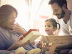 Family celebrating mothers day in bed. Space for copy.