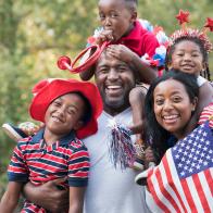 Portrait of Black family celebrating 4th of July in park