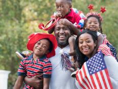 Portrait of Black family celebrating 4th of July in park