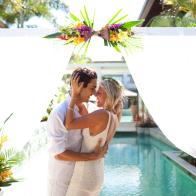 Bride and groom laughing  kissing tropical resort