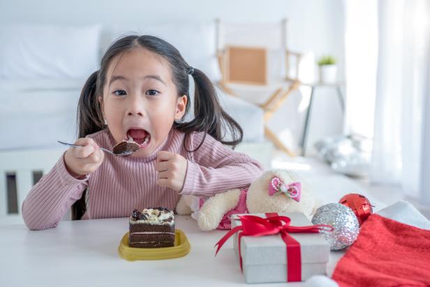 Little girl eating birthday cake