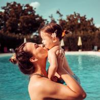 Mother and baby girl at swimming pool