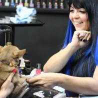 Lexi Martone applying nail polish to client Rula’s dog.