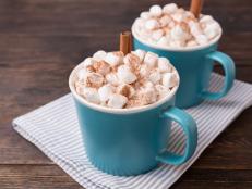 Blue mugs of cocoa, delicious dessert for cold weather or Christmas time. Hot cocoa in cups.