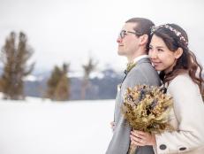 Cute young Asian female and caucasian male couple on their wedding day in the snow