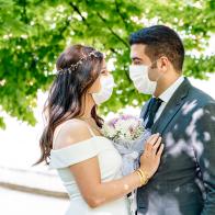 bride and groom in a face protection mask