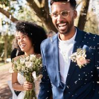 Shot of a happy newlywed young couple getting showered with confetti outdoors on their wedding day