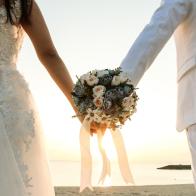 Two couple have bouquet at the sunset beach