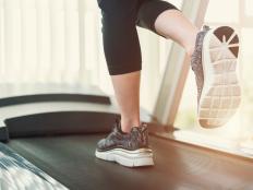 Healthy and fitness concept. Sport people running on treadmill at gym in the morning with sunlight. Close up of shoes shot with free copy space background.