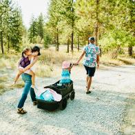 Family walking down driveway of vacation home on summer evening