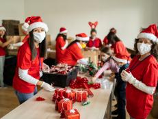 Female volunteers preparing Christmas gifts for poor people