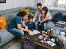 Mother explaining to her family the assembly point map while preparing emergency backpacks