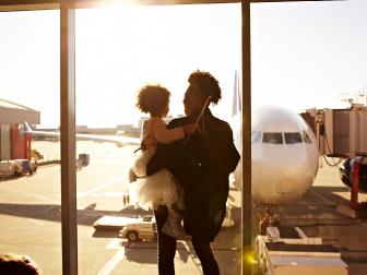 Mother holding daughter at airport