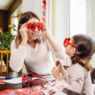 Mother and young daughter making greeting cards for Valentine's Day