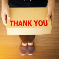 Thank you message for customer who shopping with your shop concept : Thank you message word on simple delivery brown box in hand of friendly sender man