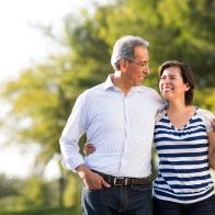 Loving happy mature couple together at walk in a park