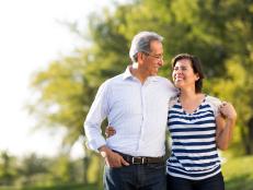 Loving happy mature couple together at walk in a park