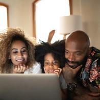 Happy family watching movie on a laptop
