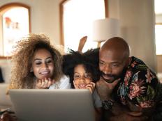 Happy family watching movie on a laptop