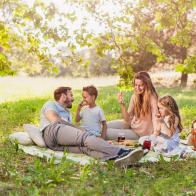 Fruits of summer enjoyed by a young beautiful family