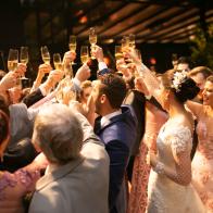 Bride, groom and wedding guests making a toast