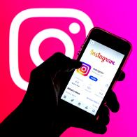 SPAIN - 2021/03/29: In this photo illustration, the Instagram app in App Store seen displayed on a smartphone screen and a Instagram logo in the background. (Photo Illustration by Thiago Prudencio/SOPA Images/LightRocket via Getty Images)