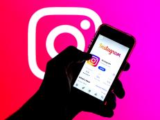 SPAIN - 2021/03/29: In this photo illustration, the Instagram app in App Store seen displayed on a smartphone screen and a Instagram logo in the background. (Photo Illustration by Thiago Prudencio/SOPA Images/LightRocket via Getty Images)