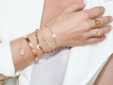woman neck with hand with many bracelets