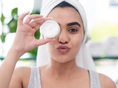 Shot of young woman posing with facial moisturiser