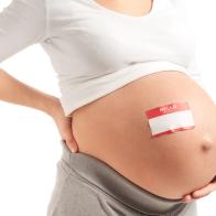 Pregnant Woman with Name Tag on Bare Belly