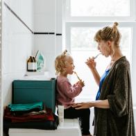 Photo series of a young mother with a child doing different chores at home. Shot in Berlin.